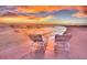 Two beach chairs on a pristine shoreline at sunset at 51 Palm Dr, Placida, FL 33946