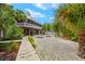 Elevated home with boardwalk, tropical landscaping, and firepit at 51 Palm Dr, Placida, FL 33946