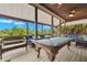 Screened porch with pool table and comfy seating at 51 Palm Dr, Placida, FL 33946