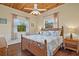 King bedroom with wicker bed frame and hardwood floors at 51 Palm Dr, Placida, FL 33946