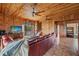 Relaxing living room featuring leather sofas and wood-paneled walls at 51 Palm Dr, Placida, FL 33946