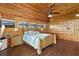 Main bedroom with wood-paneled walls, a king-size bed, and hardwood floors at 51 Palm Dr, Placida, FL 33946