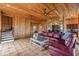 Spacious living area with wood paneling and sectional sofa at 51 Palm Dr, Placida, FL 33946
