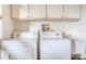 Laundry room with washer, dryer, cabinets, and utility sink at 285 Mark Twain Ln, Rotonda West, FL 33947