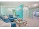 Living area with blue sectional sofa and TV at 285 Mark Twain Ln, Rotonda West, FL 33947