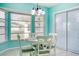 Charming dining area with white table and chairs, near the kitchen at 285 Mark Twain Ln, Rotonda West, FL 33947