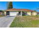 House exterior, single-story home with a garage and driveway at 285 Mark Twain Ln, Rotonda West, FL 33947