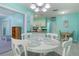 Bright dining area with white table and chairs, adjacent to kitchen at 285 Mark Twain Ln, Rotonda West, FL 33947