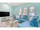 Living room with sectional sofa and large TV at 285 Mark Twain Ln, Rotonda West, FL 33947