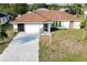 Aerial view of a single-story house on a residential street at 285 Mark Twain Ln, Rotonda West, FL 33947