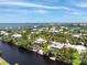 Beautiful aerial view showcasing home's waterfront location, dock, and lush greenery at 13074 Via Flavia, Placida, FL 33946