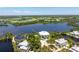 Gorgeous aerial perspective of the home nestled amidst lush greenery in a waterfront community at 13074 Via Flavia, Placida, FL 33946