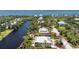 Stunning aerial view of waterfront home with lush landscaping and private dock at 13074 Via Flavia, Placida, FL 33946