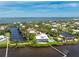 Spectacular aerial view highlighting waterfront home's serene setting and lush surroundings at 13074 Via Flavia, Placida, FL 33946