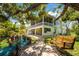 Outdoor living space with swing, bench, and lush landscaping at 13074 Via Flavia, Placida, FL 33946