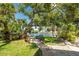 Relaxing backyard retreat with lush greenery, waterfront views, and seating at 13074 Via Flavia, Placida, FL 33946