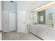 Bright bathroom includes double sinks, large vanity mirror, and ample storage space at 13074 Via Flavia, Placida, FL 33946