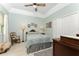 Cozy guest bedroom with ceiling fan, tile flooring, and ample natural light at 13074 Via Flavia, Placida, FL 33946