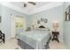 Well-lit guest bedroom with ceiling fan, tiled floors, and ample natural light at 13074 Via Flavia, Placida, FL 33946