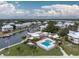 Resort-style community pool, clubhouse, and marina with waterfront views at 13074 Via Flavia, Placida, FL 33946