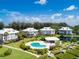 Inviting community pool area with lush landscaping and surrounding homes at 13074 Via Flavia, Placida, FL 33946
