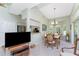 Dining room with vaulted ceilings, large window, and view of kitchen at 13074 Via Flavia, Placida, FL 33946