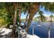 Private dock with waterfront views and lush palm trees at 13074 Via Flavia, Placida, FL 33946
