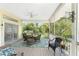 Screened porch with wicker furniture, and lush greenery views at 13074 Via Flavia, Placida, FL 33946
