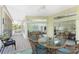 Spacious screened porch with dining area, seating, and access to the interior at 13074 Via Flavia, Placida, FL 33946
