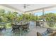 Screened porch with seating area, dining table, and lush views at 13074 Via Flavia, Placida, FL 33946
