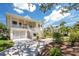 Charming two-story home with a welcoming front porch and landscaped yard at 13074 Via Flavia, Placida, FL 33946