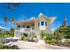 Charming two-story home with a welcoming front porch and landscaped yard at 13074 Via Flavia, Placida, FL 33946