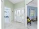 Bright foyer with decorative glass front door and tiled floors at 13074 Via Flavia, Placida, FL 33946