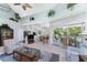 Living room with vaulted ceiling, dining area and sliding glass door to a balcony at 13074 Via Flavia, Placida, FL 33946