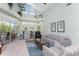 Bright living room with high ceilings, large windows, and access to a balcony at 13074 Via Flavia, Placida, FL 33946
