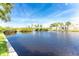Serene waterfront view with lush greenery and clear blue skies at 13074 Via Flavia, Placida, FL 33946