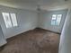 Spacious bedroom with carpet, ceiling fan, and large windows at 22481 Westchester Blvd # B35, Punta Gorda, FL 33980