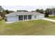 Single-story home with a large front yard and driveway at 13034 Marathon Blvd, Port Charlotte, FL 33981