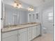 Double vanity bathroom with granite countertops and white cabinets at 13034 Marathon Blvd, Port Charlotte, FL 33981