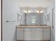 Double vanity bathroom with granite countertops and tiled shower at 13034 Marathon Blvd, Port Charlotte, FL 33981