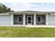 Covered porch with screened enclosure and light blue exterior at 13034 Marathon Blvd, Port Charlotte, FL 33981