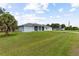 Light blue house with a screened porch and lawn at 13034 Marathon Blvd, Port Charlotte, FL 33981