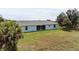 Home's backyard, featuring a large grassy area at 13034 Marathon Blvd, Port Charlotte, FL 33981