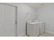 Laundry room with washer, dryer, and shelving at 13034 Marathon Blvd, Port Charlotte, FL 33981