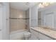 Bathroom with tub, toilet, and granite vanity at 13034 Marathon Blvd, Port Charlotte, FL 33981
