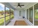 Screened lanai with tile flooring, sliding doors, and ceiling fan at 13034 Marathon Blvd, Port Charlotte, FL 33981