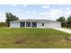 Newly built home with light blue exterior and a large yard at 13034 Marathon Blvd, Port Charlotte, FL 33981