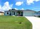 Charming light teal house with a two-car garage at 12112 Helios Ave, Port Charlotte, FL 33981