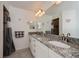 Double vanity bathroom with granite countertops and walk-in shower at 12112 Helios Ave, Port Charlotte, FL 33981