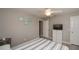 Bedroom with ceiling fan, dresser, and striped bedding at 12112 Helios Ave, Port Charlotte, FL 33981